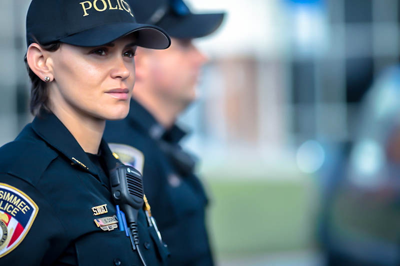 police woman using digital two-way radio