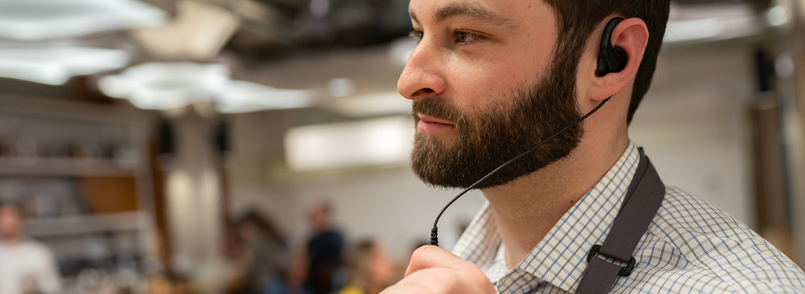Man wearing a two-way radio earpiece headset